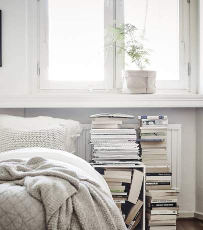 Stacked books and magazines on the floor
